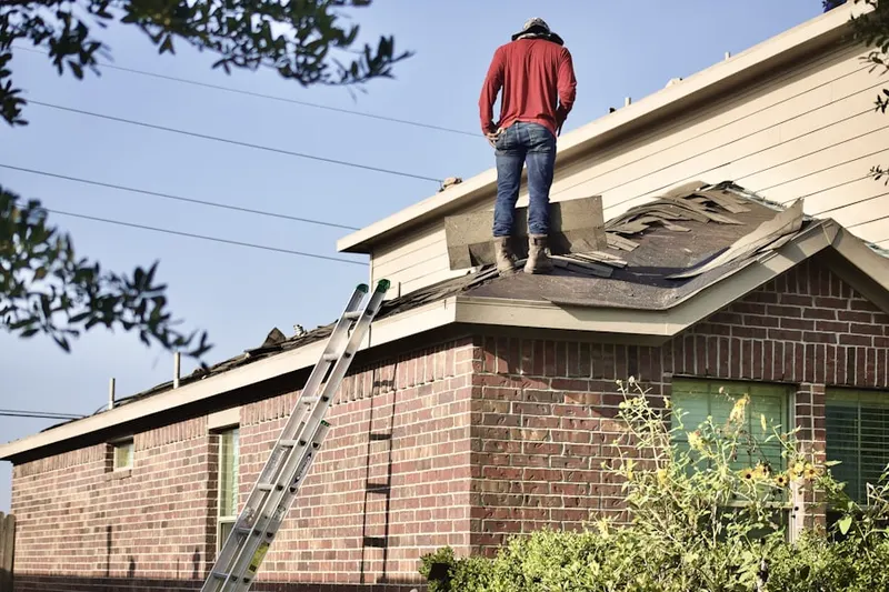 Professional roofer working on a residential roof in Fairfax Farms